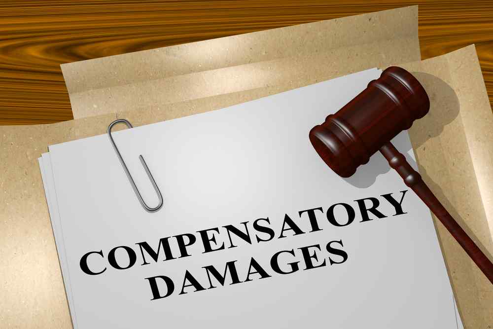 Gavel on top of file with the words compensatory damages